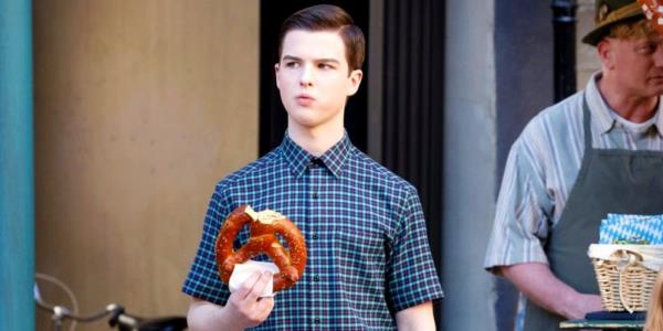 Sheldon eating a pretzel in Germany in Young Sheldon season 7